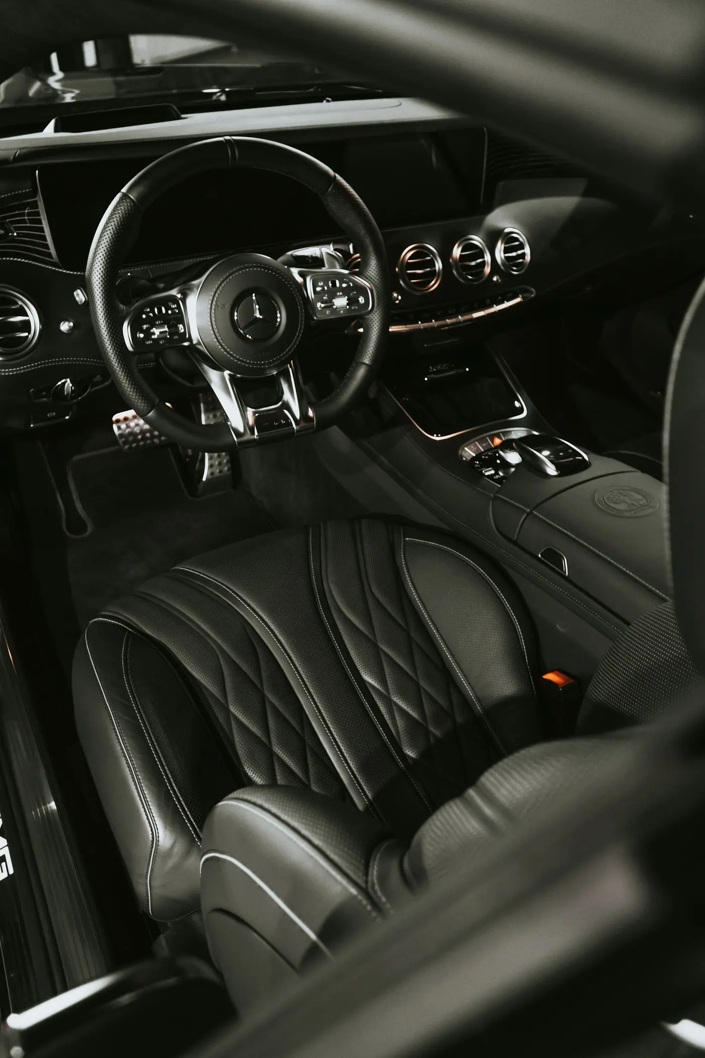 Black leather interior and steering wheel of a luxury vehicle